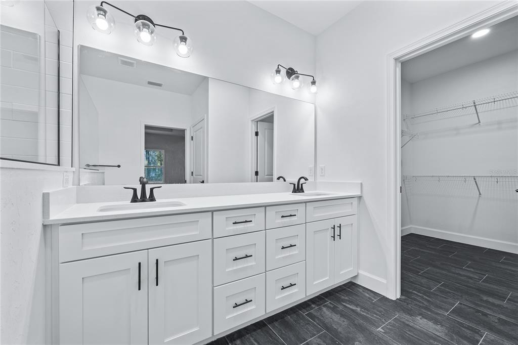 6682 Southwest 10th Lane Gainesville, FL 32607 - Photo 10 of 28 a bathroom with double sink and a mirror