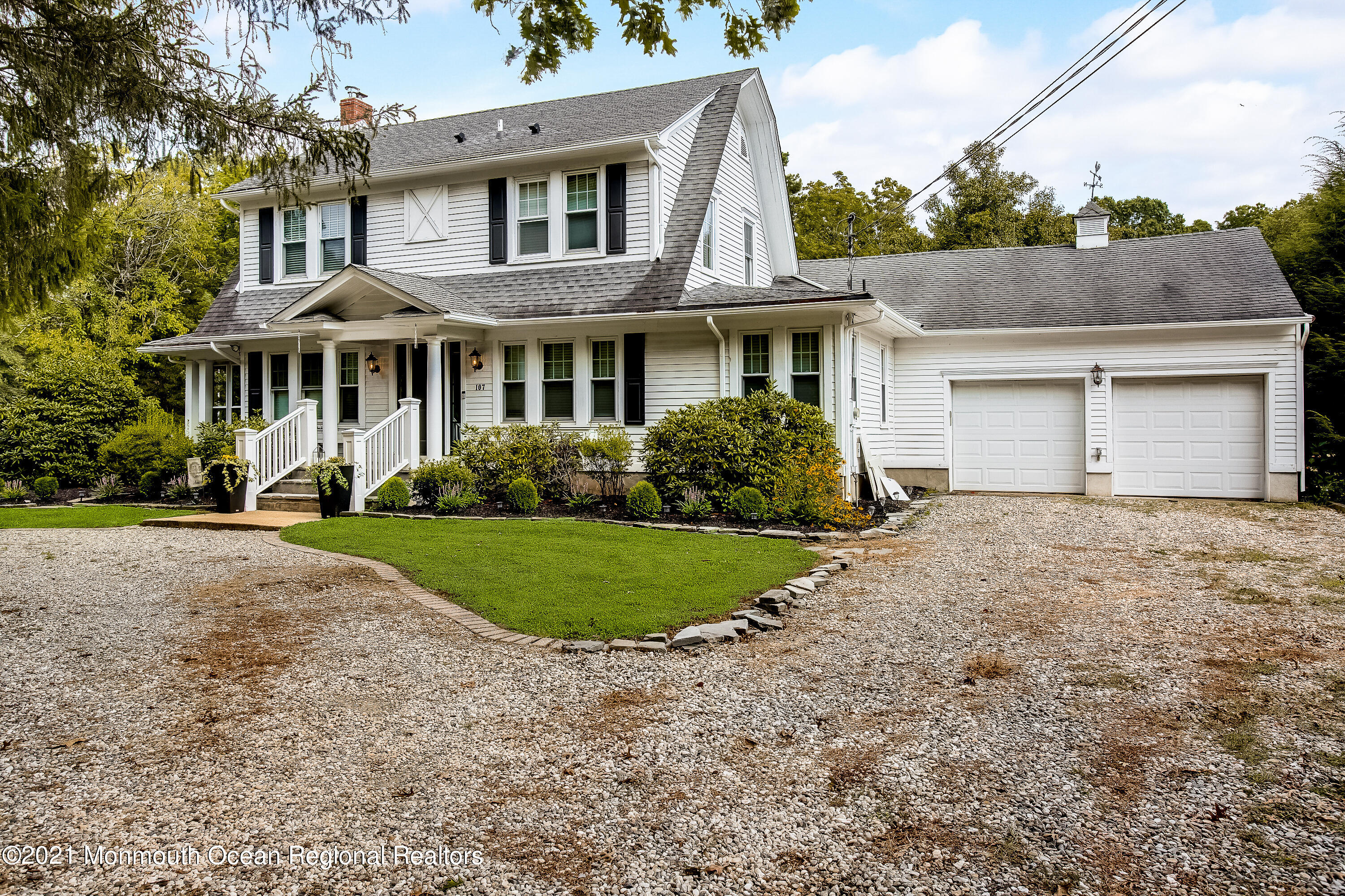 107 Brown Road Howell, NJ 07731 - Photo 2 of 43 a front view of a house with a garden and trees