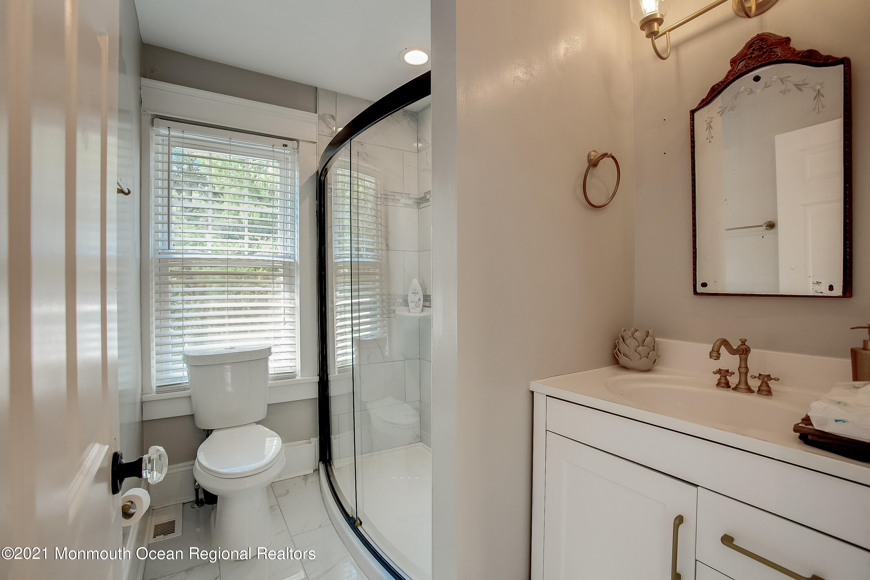 107 Brown Road Howell, NJ 07731 - Photo 21 of 43 a bathroom with a toilet sink a mirror and shower