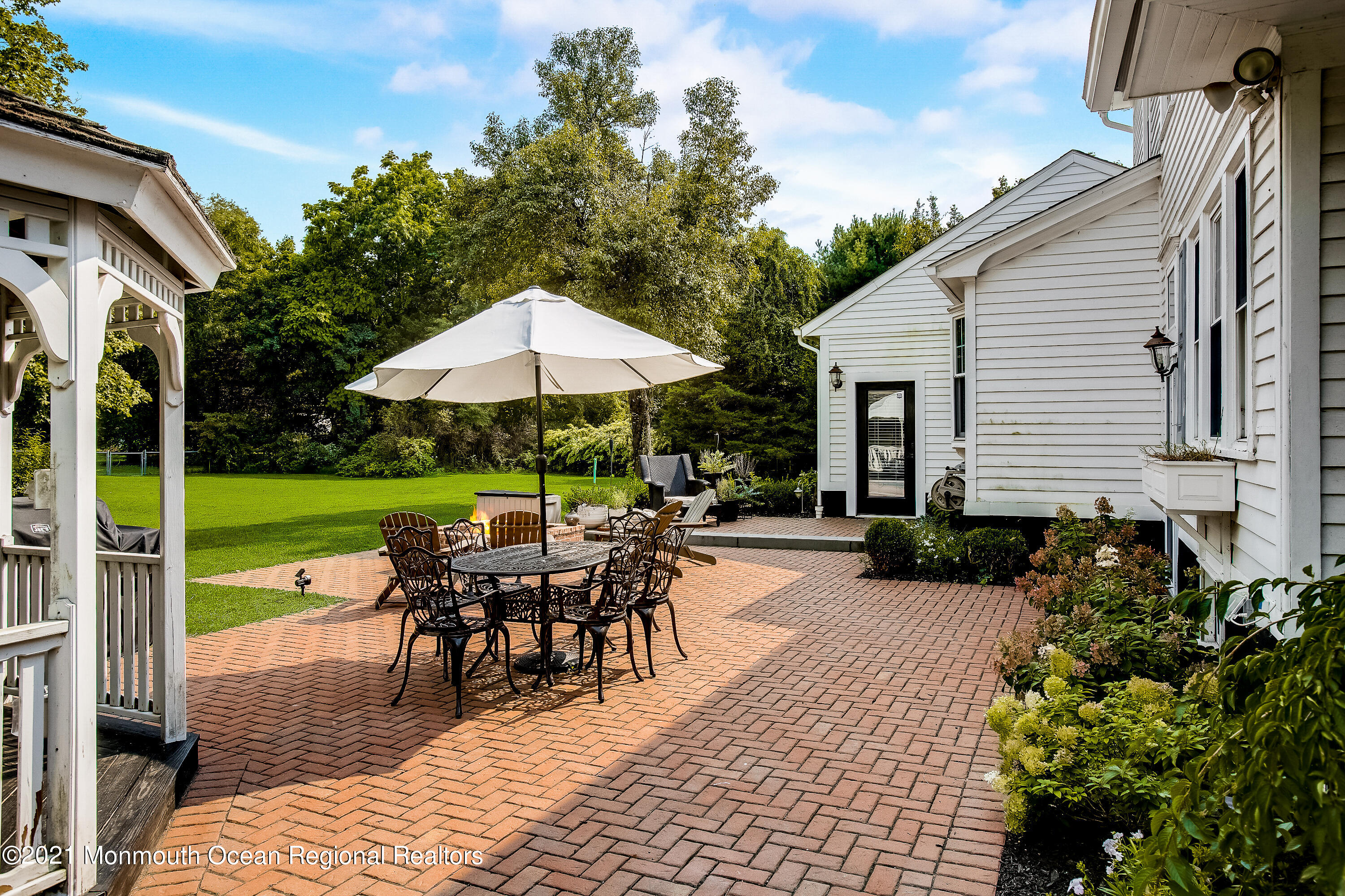 107 Brown Road Howell, NJ 07731 - Photo 32 of 43 a view of a house with backyard sitting area and garden