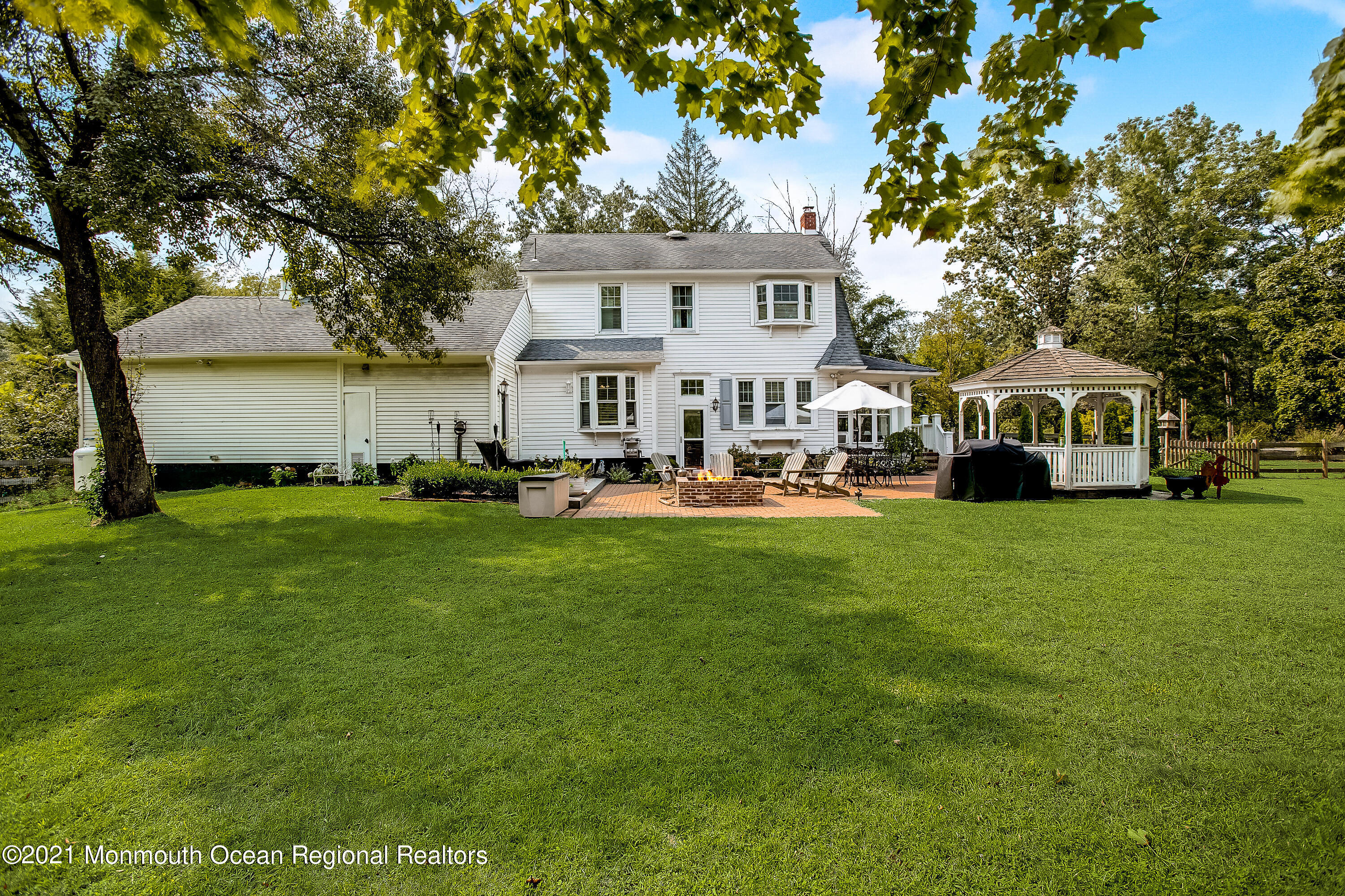 107 Brown Road Howell, NJ 07731 - Photo 33 of 43 a front view of a house with a garden and trees