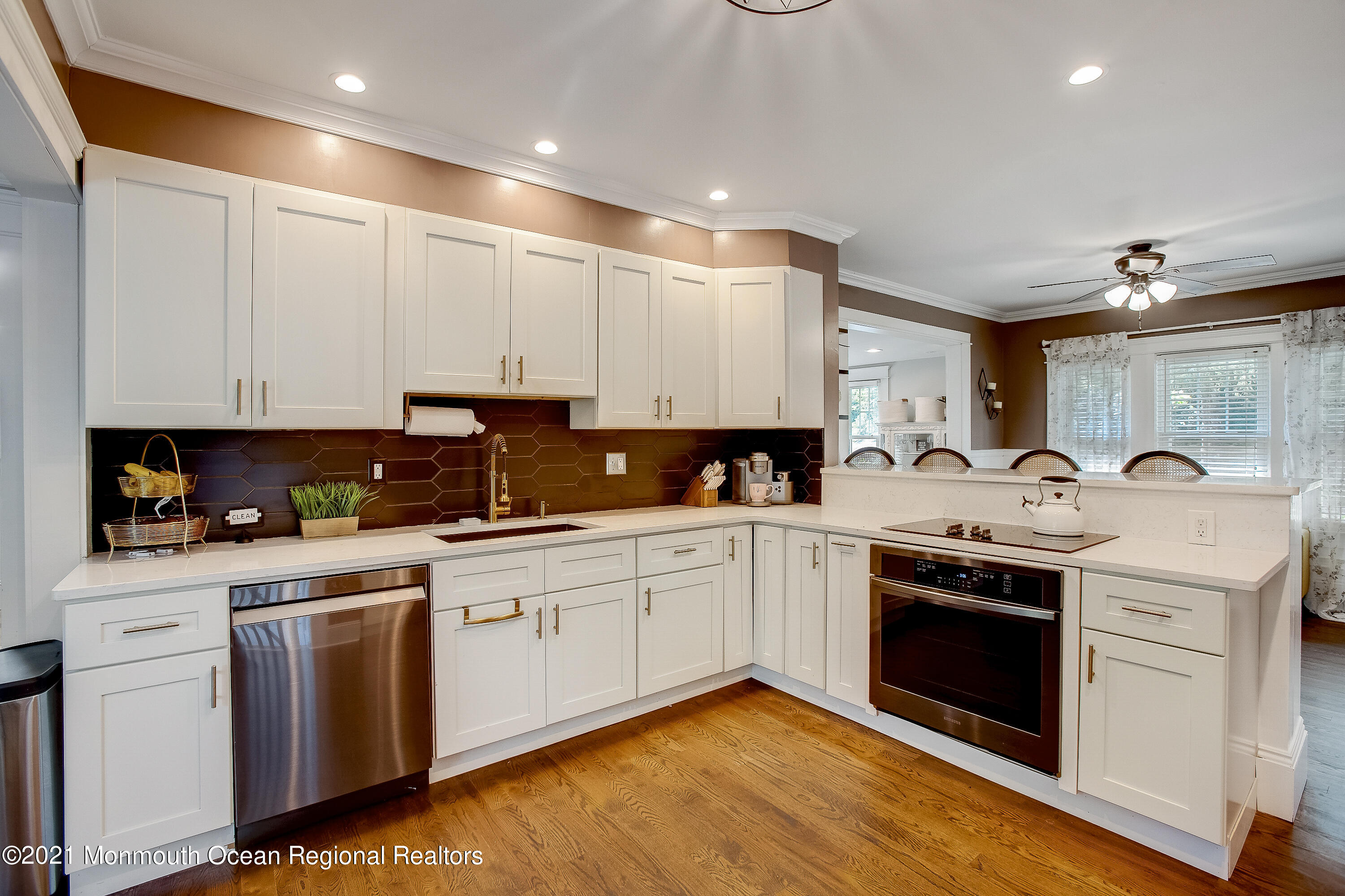 107 Brown Road Howell, NJ 07731 - Photo 8 of 43 a kitchen with granite countertop white cabinets and white appliances