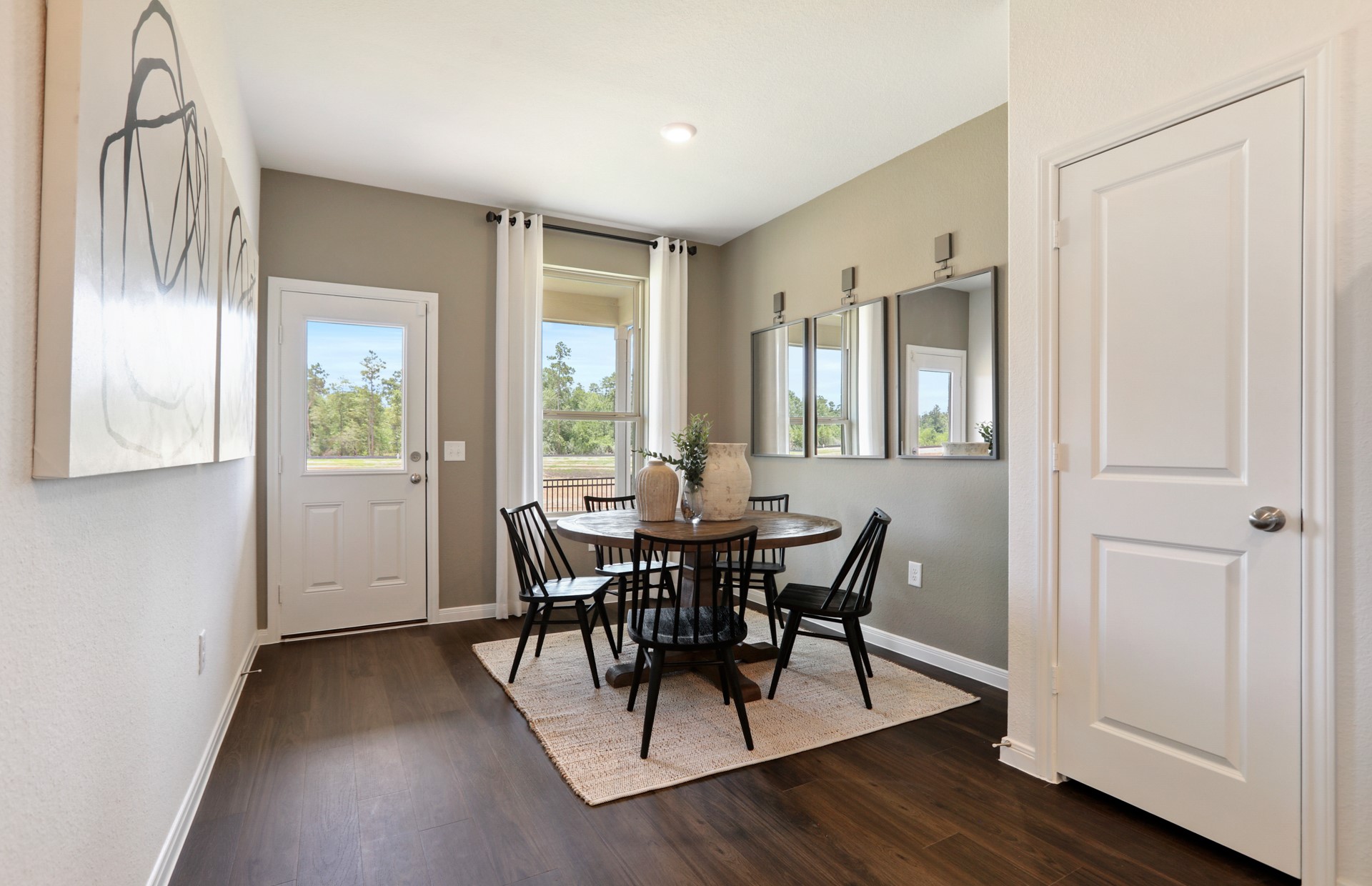 16145 Sepia Manor Street Conroe, TX 77302 - Photo 18 of 36 a view of a dining room with furniture and wooden floor