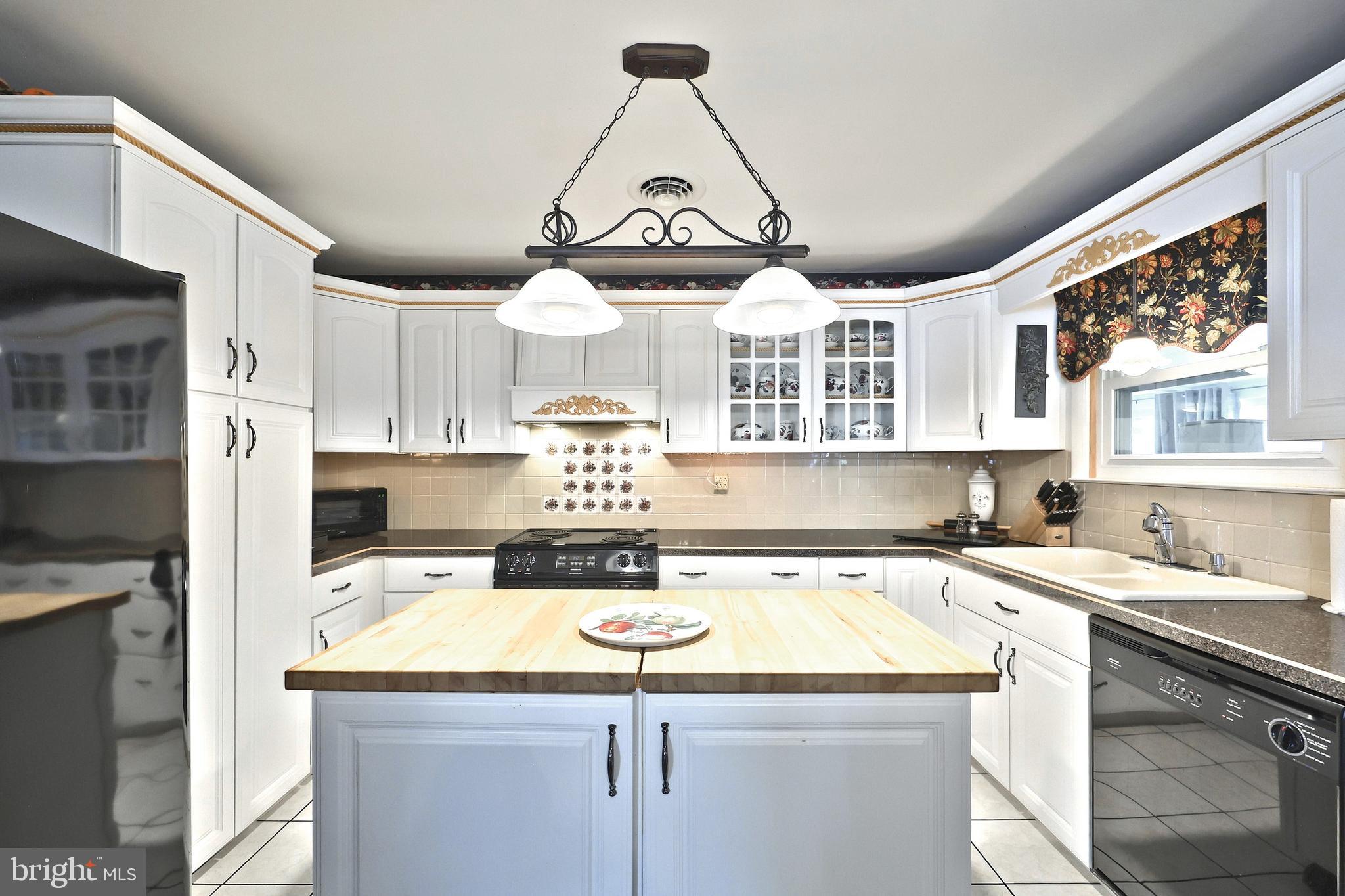 181 Harrisburg Street York Springs, PA 17372 - Photo 21 of 44 a kitchen with a sink a stove and cabinets