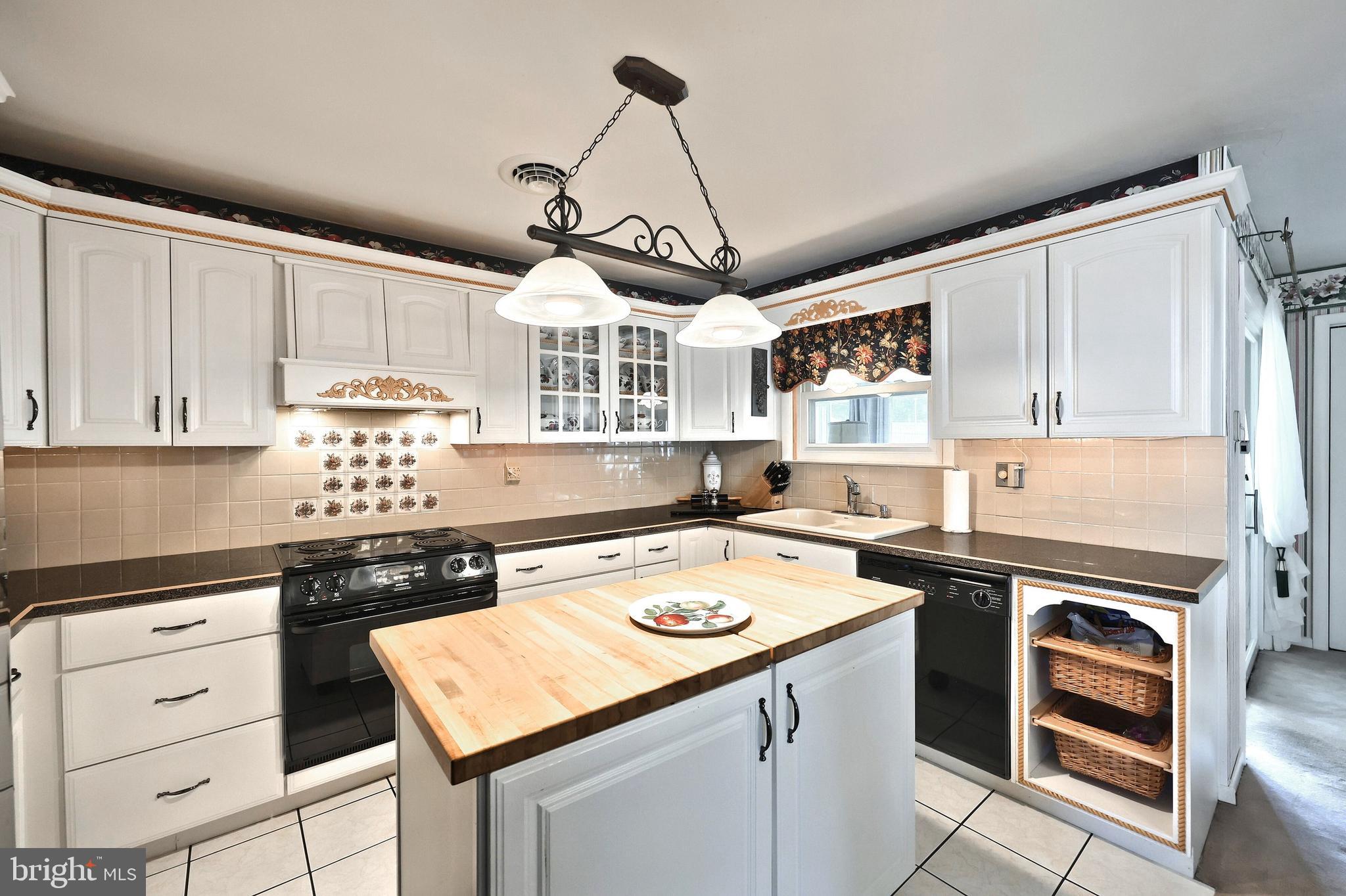 181 Harrisburg Street York Springs, PA 17372 - Photo 22 of 44 a kitchen with a stove a sink a window and cabinets