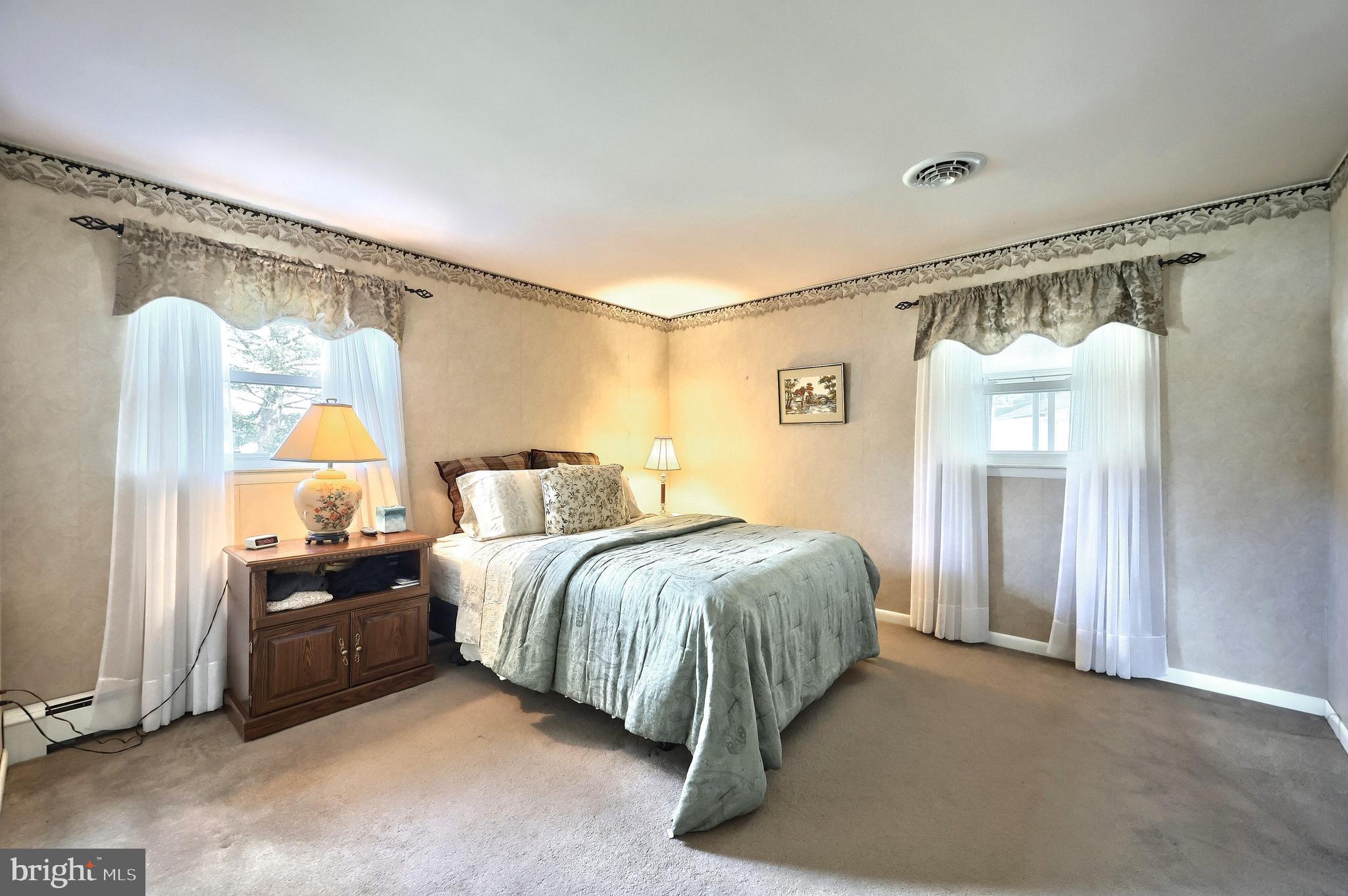 181 Harrisburg Street York Springs, PA 17372 - Photo 33 of 44 a spacious bedroom with a bed and a painting on the wall
