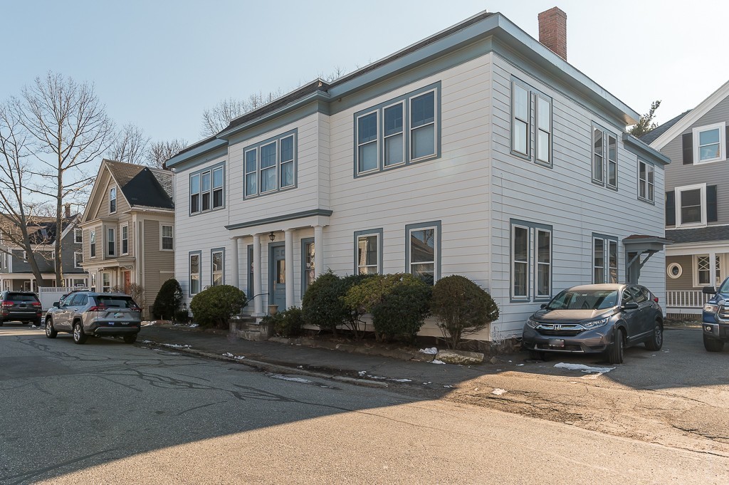 21 Thorndike Street, Unit 4 Beverly, MA 01915 - Photo 19 of 20 a front view of a building with cars parked on the roadside