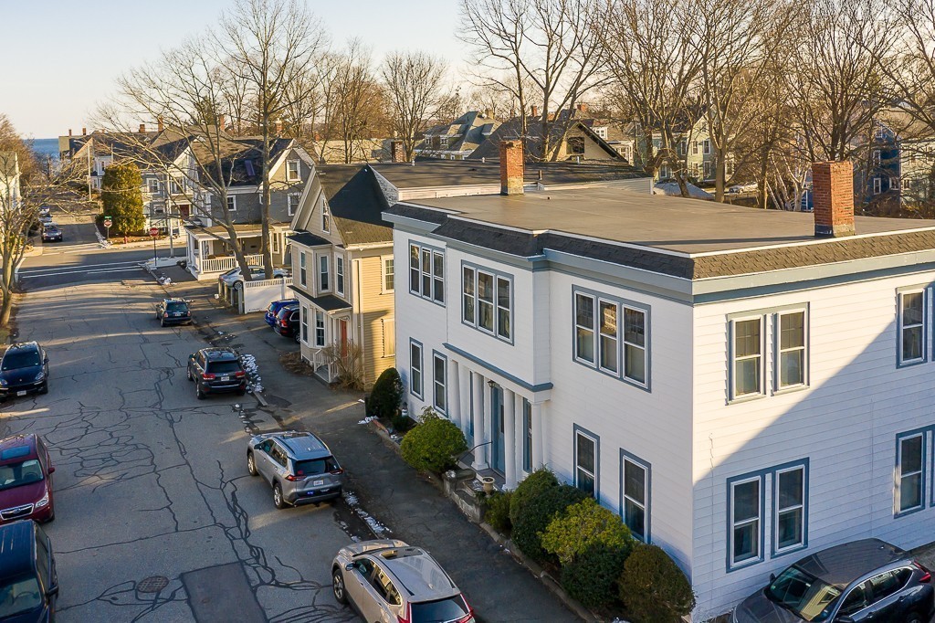 21 Thorndike Street, Unit 4 Beverly, MA 01915 - Photo 2 of 20 a tall building with trees in front of it