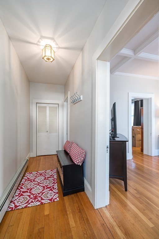 21 Thorndike Street, Unit 4 Beverly, MA 01915 - Photo 6 of 20 a living room with a rug and a wooden floor