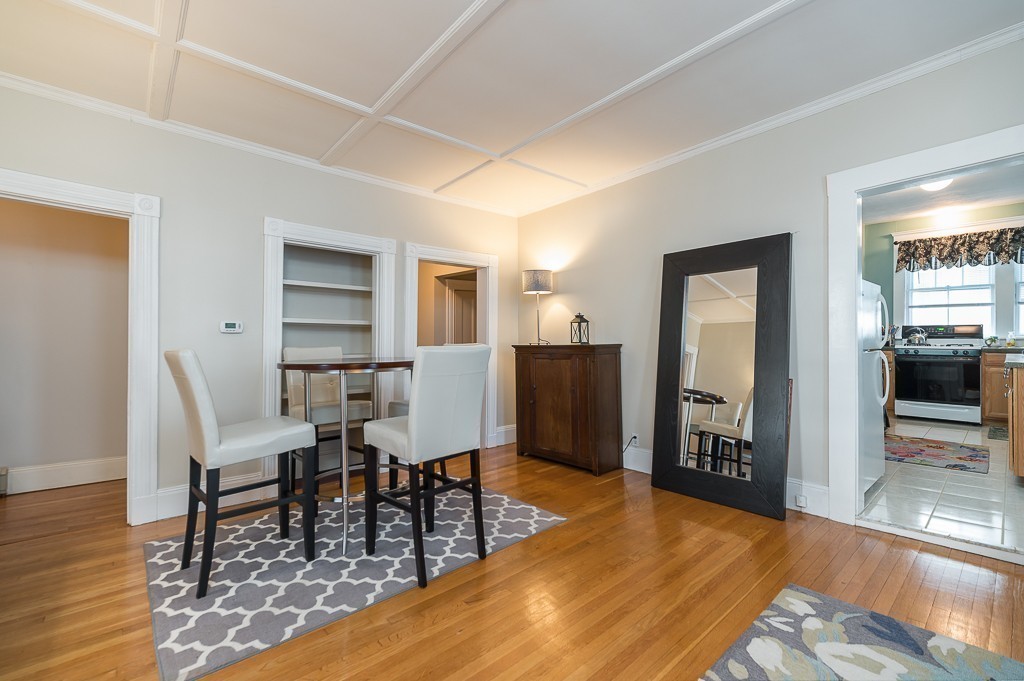 21 Thorndike Street, Unit 4 Beverly, MA 01915 - Photo 7 of 20 a view of a dining room with furniture and wooden floor