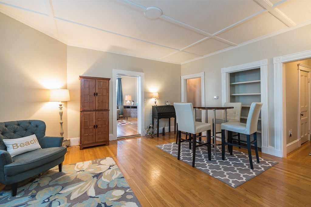 21 Thorndike Street, Unit 4 Beverly, MA 01915 - Photo 8 of 20 a living room with furniture a dining table and a refrigerator
