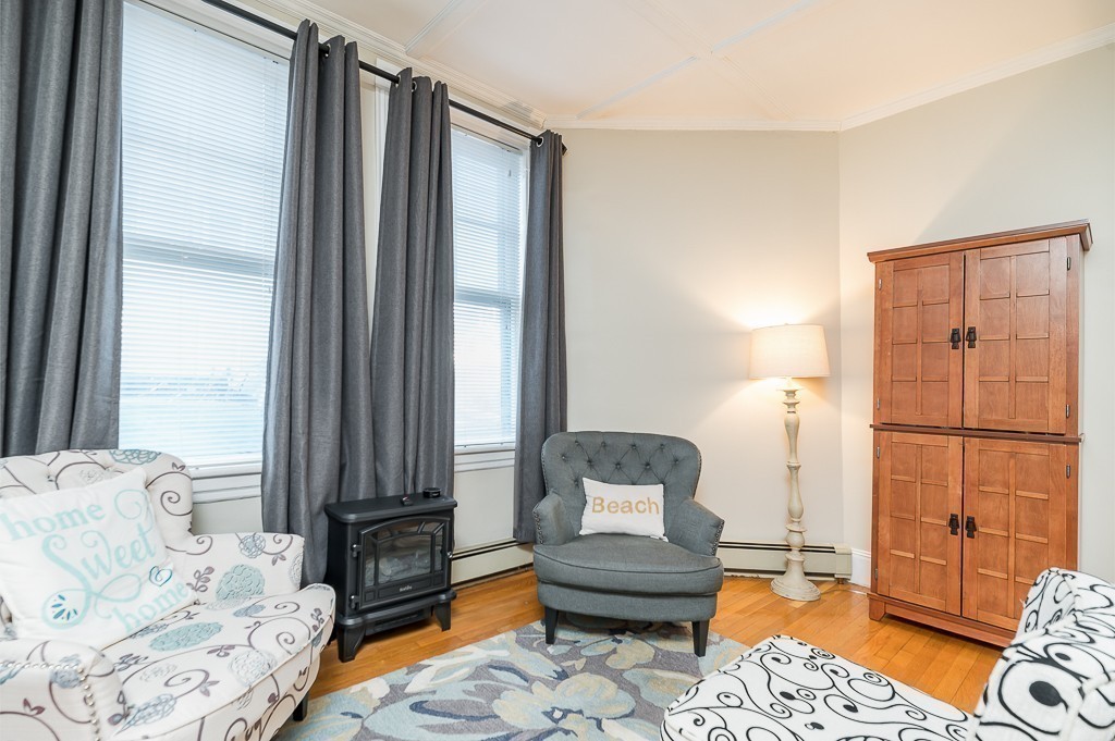 21 Thorndike Street, Unit 4 Beverly, MA 01915 - Photo 9 of 20 a living room with furniture and a window