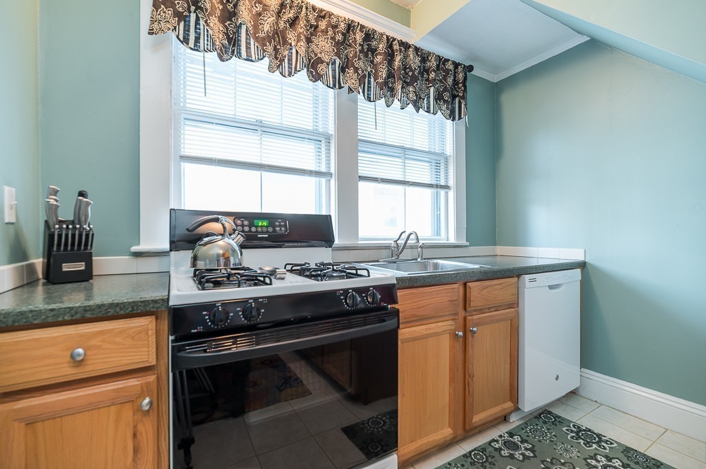 21 Thorndike Street, Unit 4 Beverly, MA 01915 - Photo 10 of 20 a kitchen with granite countertop a stove and a sink