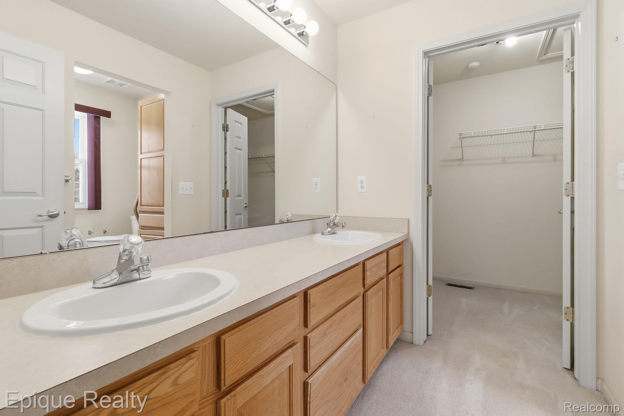 321 Cherry Grove Road Canton, MI 48188 - Photo 9 of 22 Full bathroom with a walk in closet, double vanity, and light colored carpet