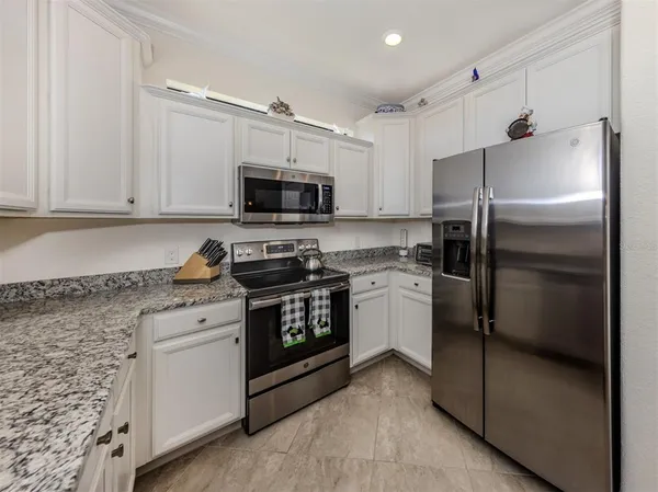 a kitchen with cabinets stainless steel appliances and a counter top space