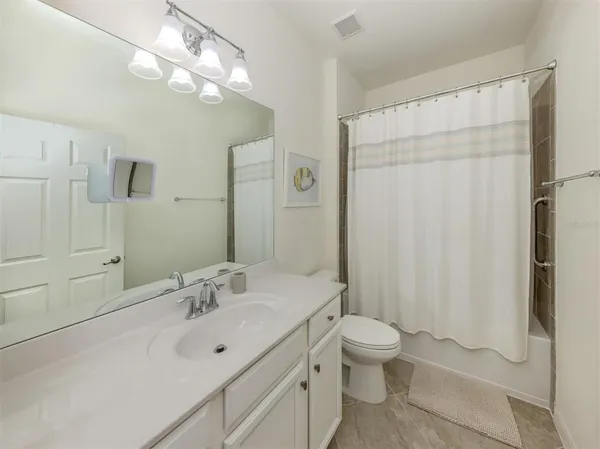 a bathroom with a double vanity sink mirror and toilet