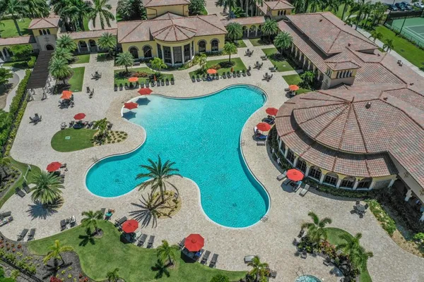 an aerial view of a swimming pool patio and outdoor seating