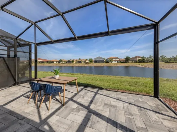 a view of a patio with a table and chairs under an umbrella