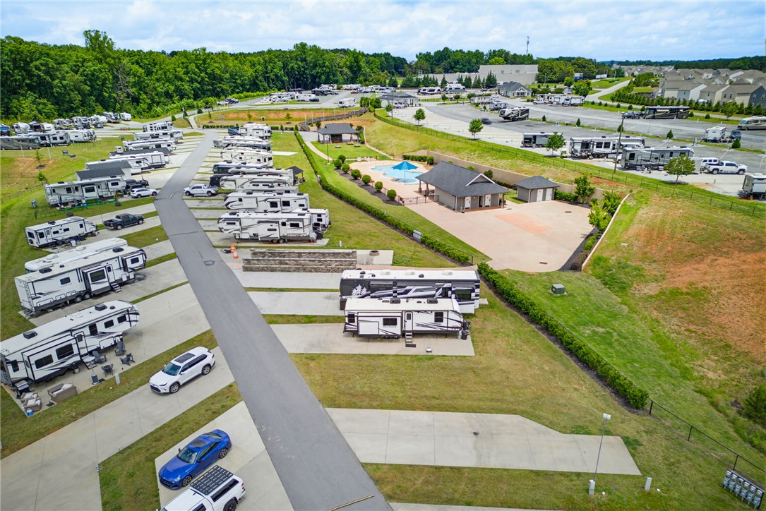 150 Dalton Drive, Unit 331/332 Pendleton, SC 29670 - Photo 9 of 29 An aerial view captures the meticulously planned layout of this community, showcasing individual parking pads and a welcoming central pool area.