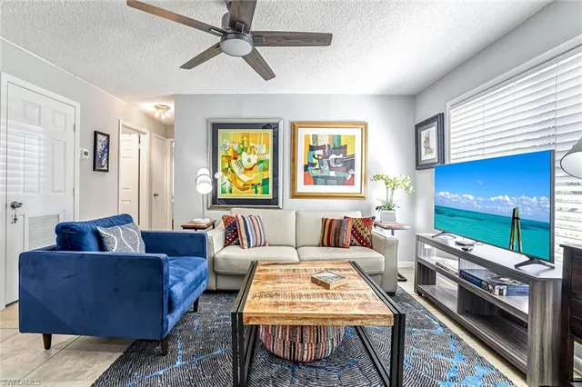 a large white kitchen with a table and chairs