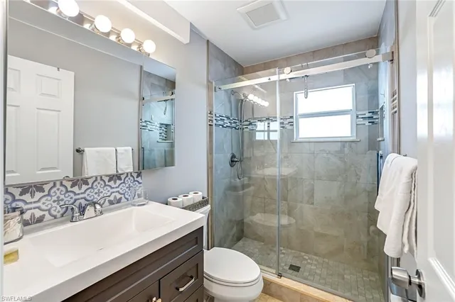 a utility room with lots of clutter and washer