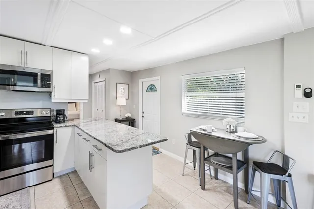 a bedroom with a white bed and a window