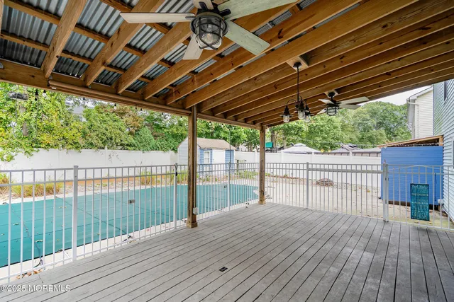 a view of backyard with a deck and wooden floor