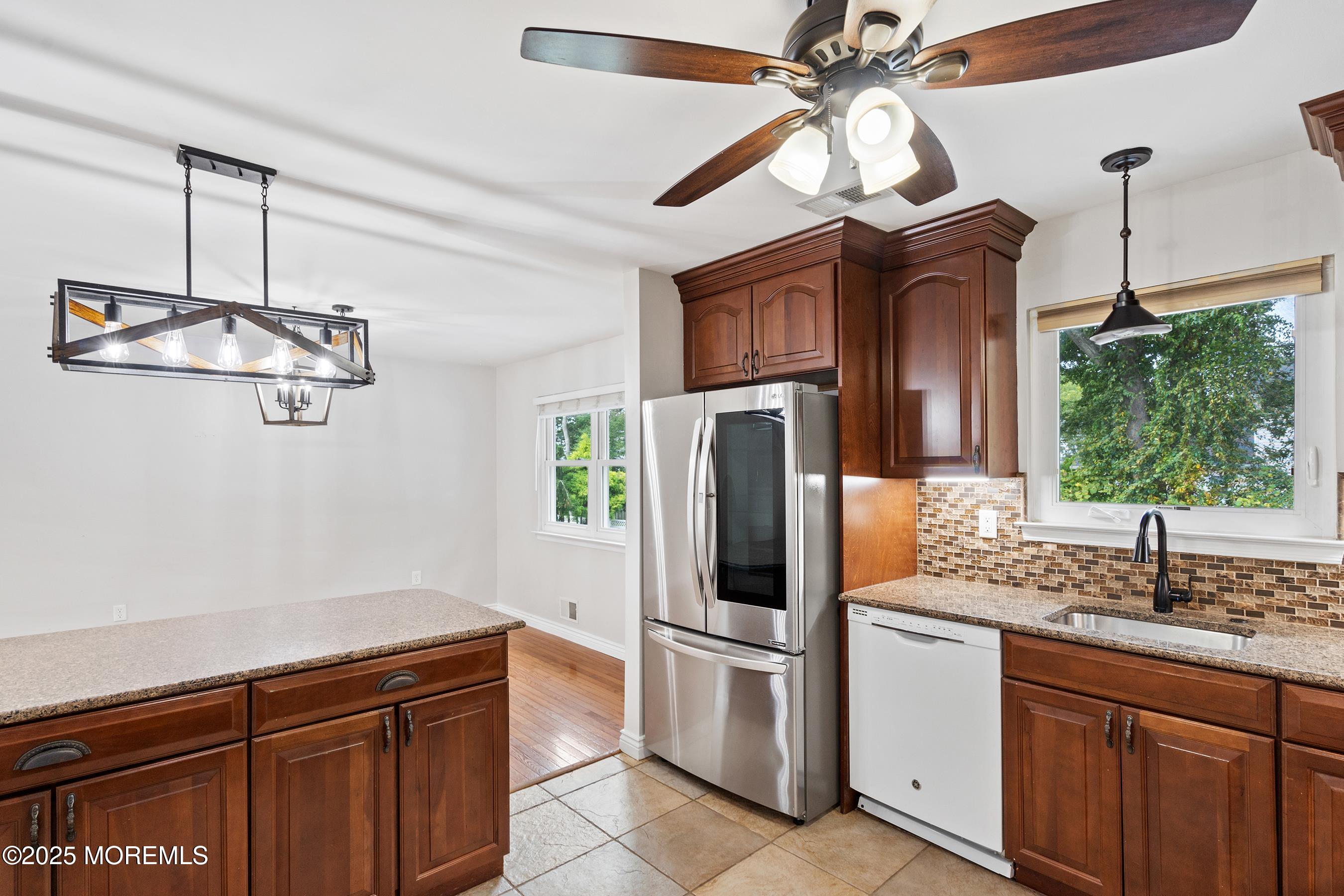 122 Moses Milch Drive Howell, NJ 07731 - Photo 5 of 15 a kitchen with stainless steel appliances a sink and a refrigerator