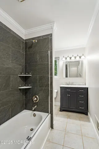 a bathroom with a tub sink and mirror