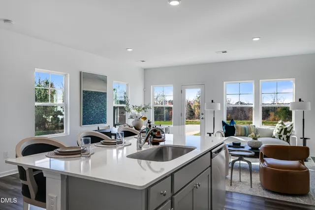 a kitchen with sink a stove and cabinets