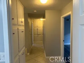 a view of a hallway with a chandelier fan