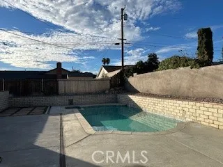 a view of a backyard with wooden fence