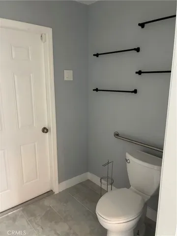 a view of a hallway with wooden shelves