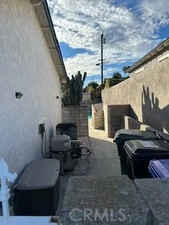 a view of a hallway with wooden floor and a door