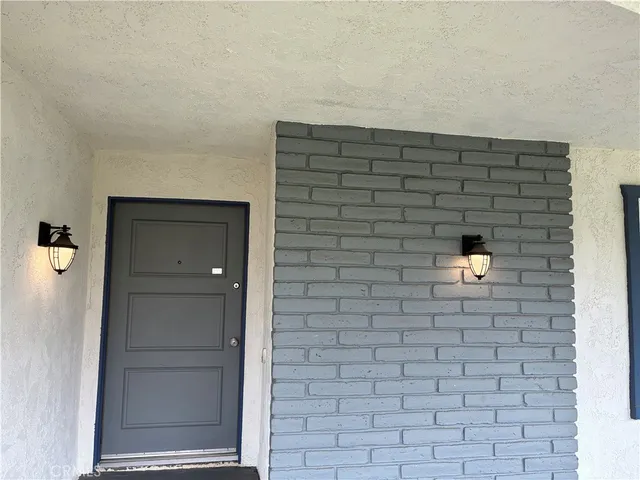 a brick house with a bench in it