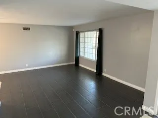 wooden floor in an empty room with a fireplace
