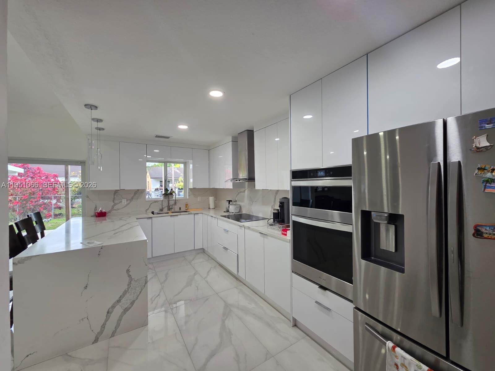 13370 Southwest 261st Terrace Homestead, FL 33032 - Photo 12 of 35 a kitchen with cabinets and stainless steel appliances