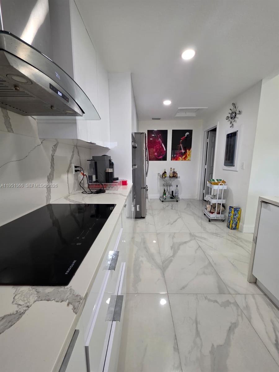 13370 Southwest 261st Terrace Homestead, FL 33032 - Photo 13 of 35 a kitchen with stainless steel appliances a sink a stove and cabinets