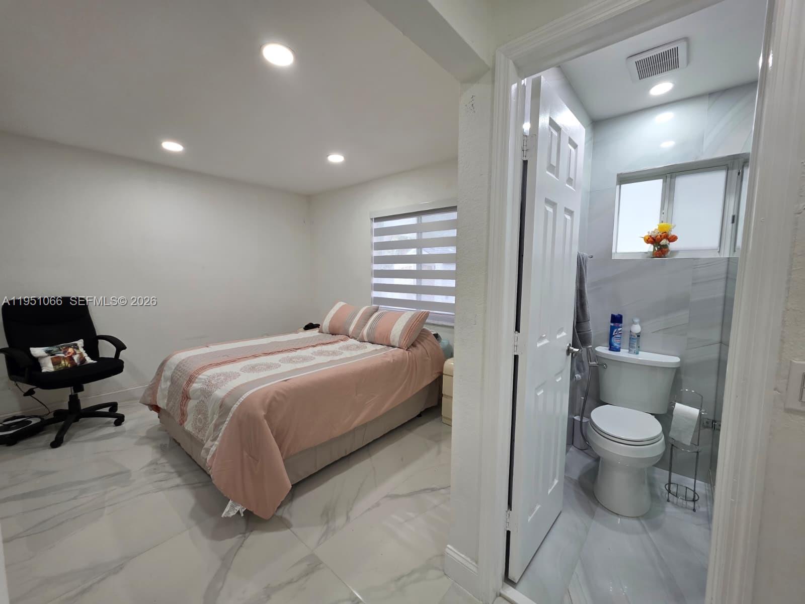 13370 Southwest 261st Terrace Homestead, FL 33032 - Photo 16 of 35 a bedroom with a bed and a view of bathroom