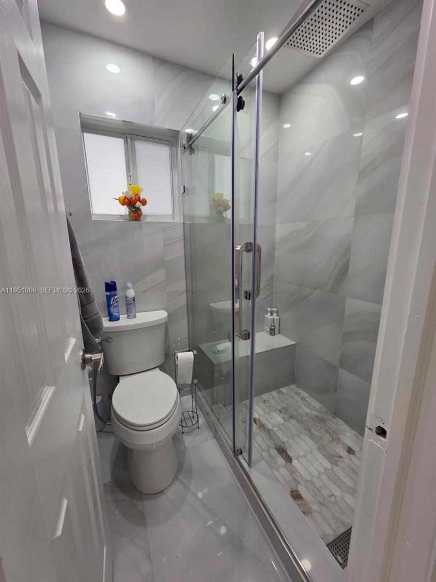 13370 Southwest 261st Terrace Homestead, FL 33032 - Photo 17 of 35 a bathroom with a toilet and a shower