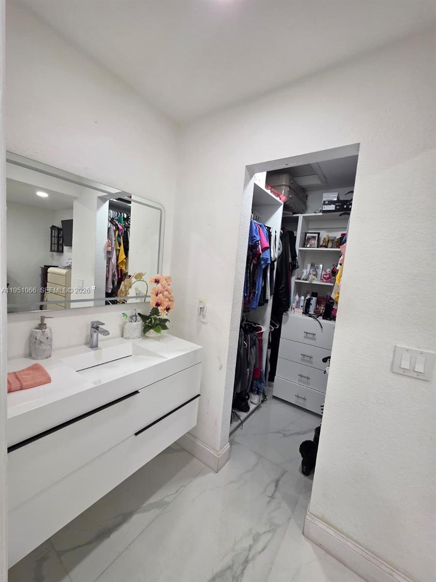 13370 Southwest 261st Terrace Homestead, FL 33032 - Photo 18 of 35 a bathroom with a sink vanity and mirror