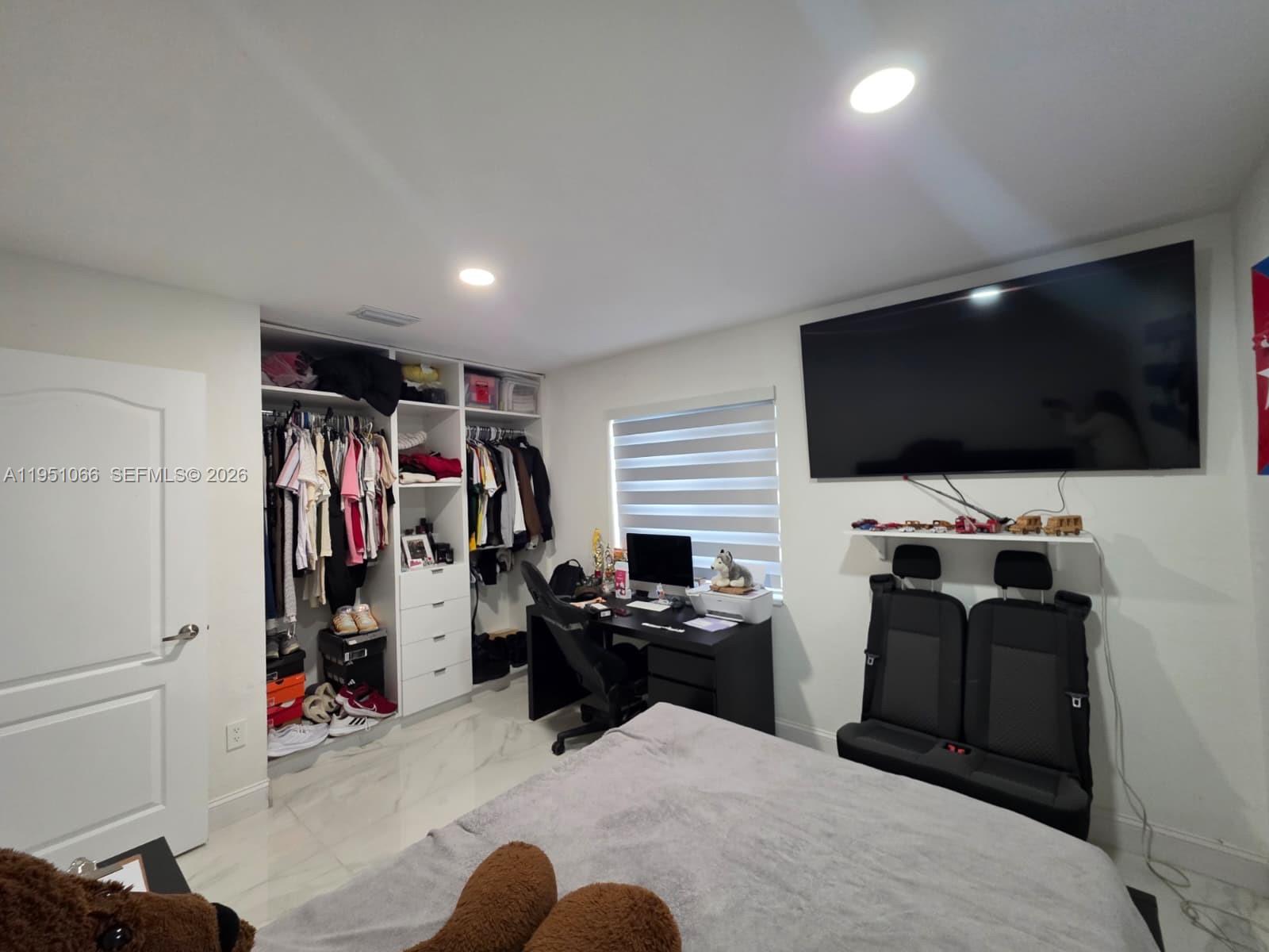 13370 Southwest 261st Terrace Homestead, FL 33032 - Photo 20 of 35 a view of a livingroom with workspace and a flat screen tv