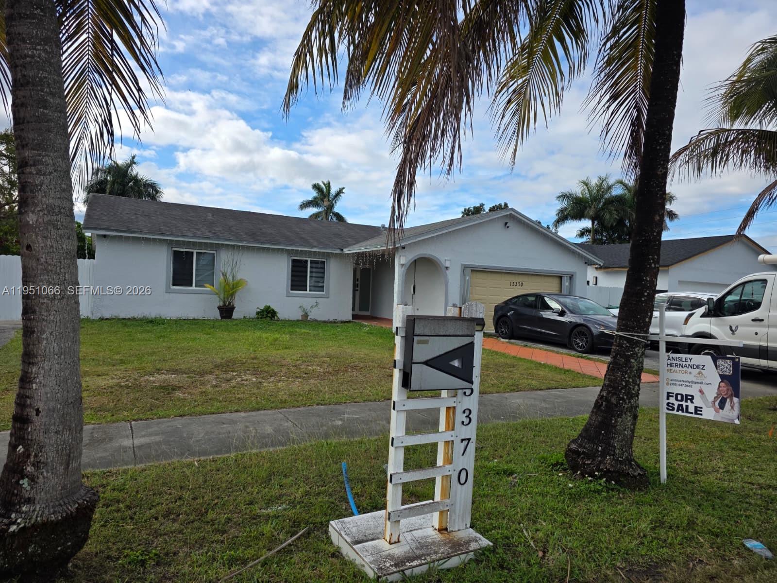 13370 Southwest 261st Terrace Homestead, FL 33032 - Photo 2 of 35 a front view of house with yard and entertaining space