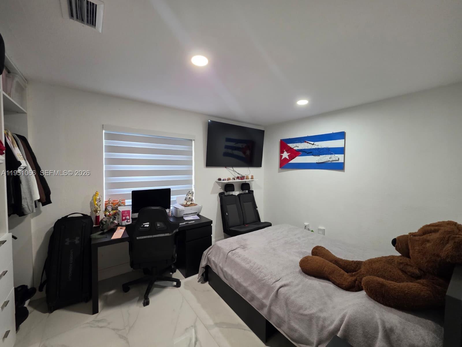 13370 Southwest 261st Terrace Homestead, FL 33032 - Photo 22 of 35 a bedroom with furniture and a flat screen tv