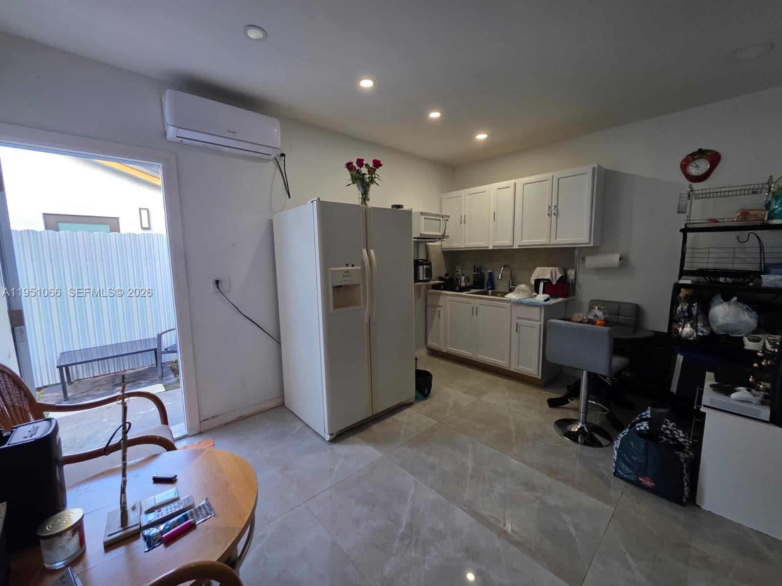13370 Southwest 261st Terrace Homestead, FL 33032 - Photo 27 of 35 a view of a kitchen with refrigerator and workspace