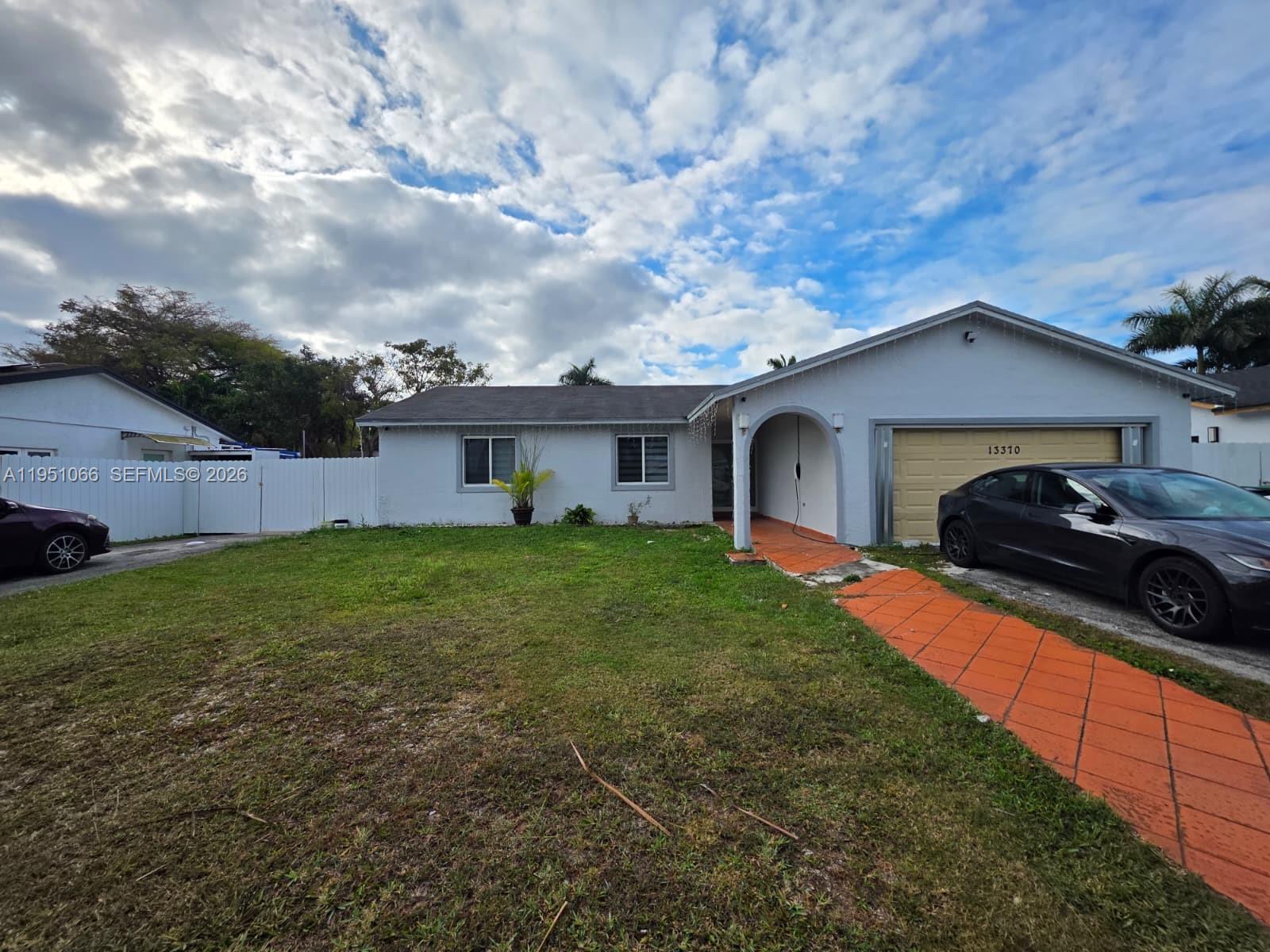 13370 Southwest 261st Terrace Homestead, FL 33032 - Photo 3 of 35 a front view of a house with garden