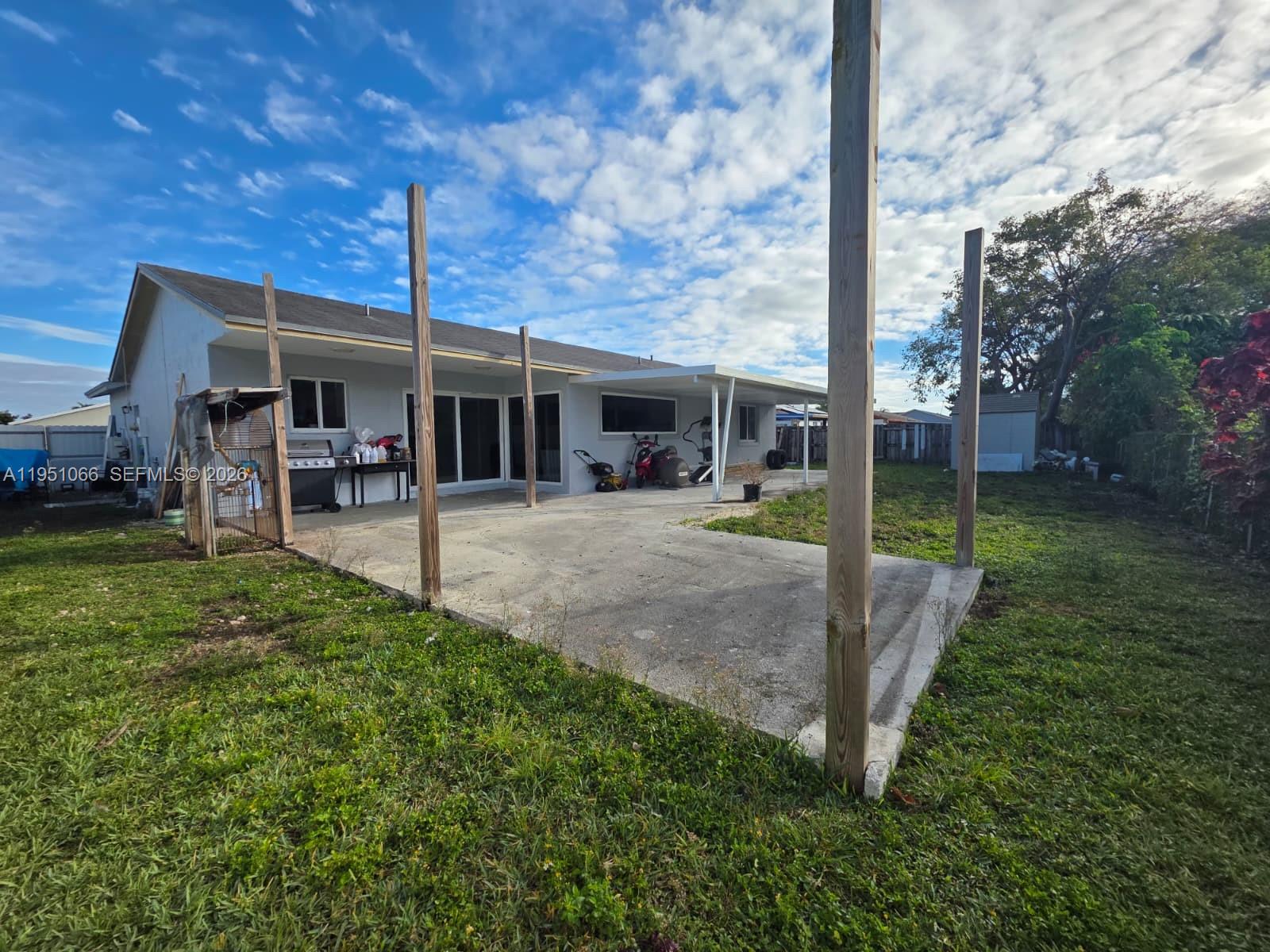 13370 Southwest 261st Terrace Homestead, FL 33032 - Photo 31 of 35 a view of a house with backyard and porch