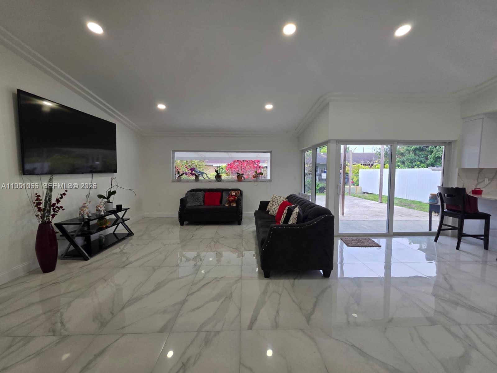 13370 Southwest 261st Terrace Homestead, FL 33032 - Photo 5 of 35 a living room with furniture and a flat screen tv