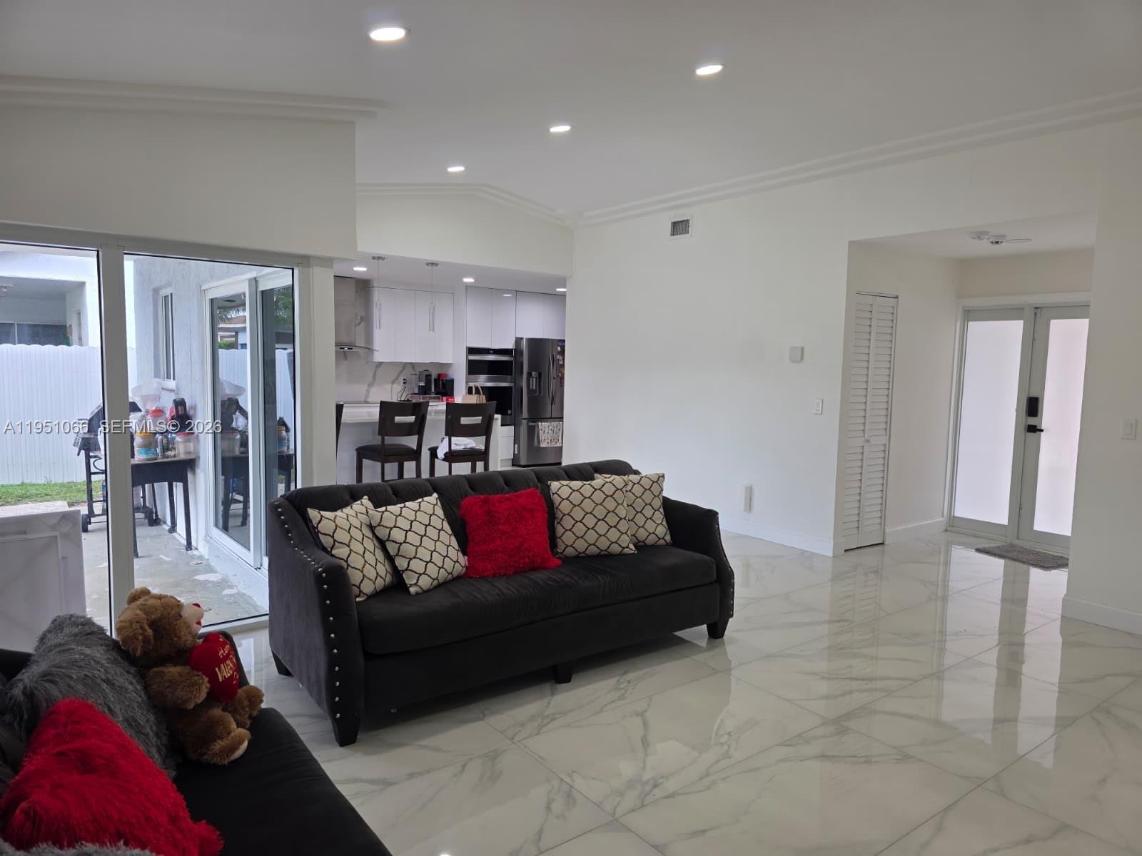 13370 Southwest 261st Terrace Homestead, FL 33032 - Photo 7 of 35 a living room with furniture and a view of kitchen