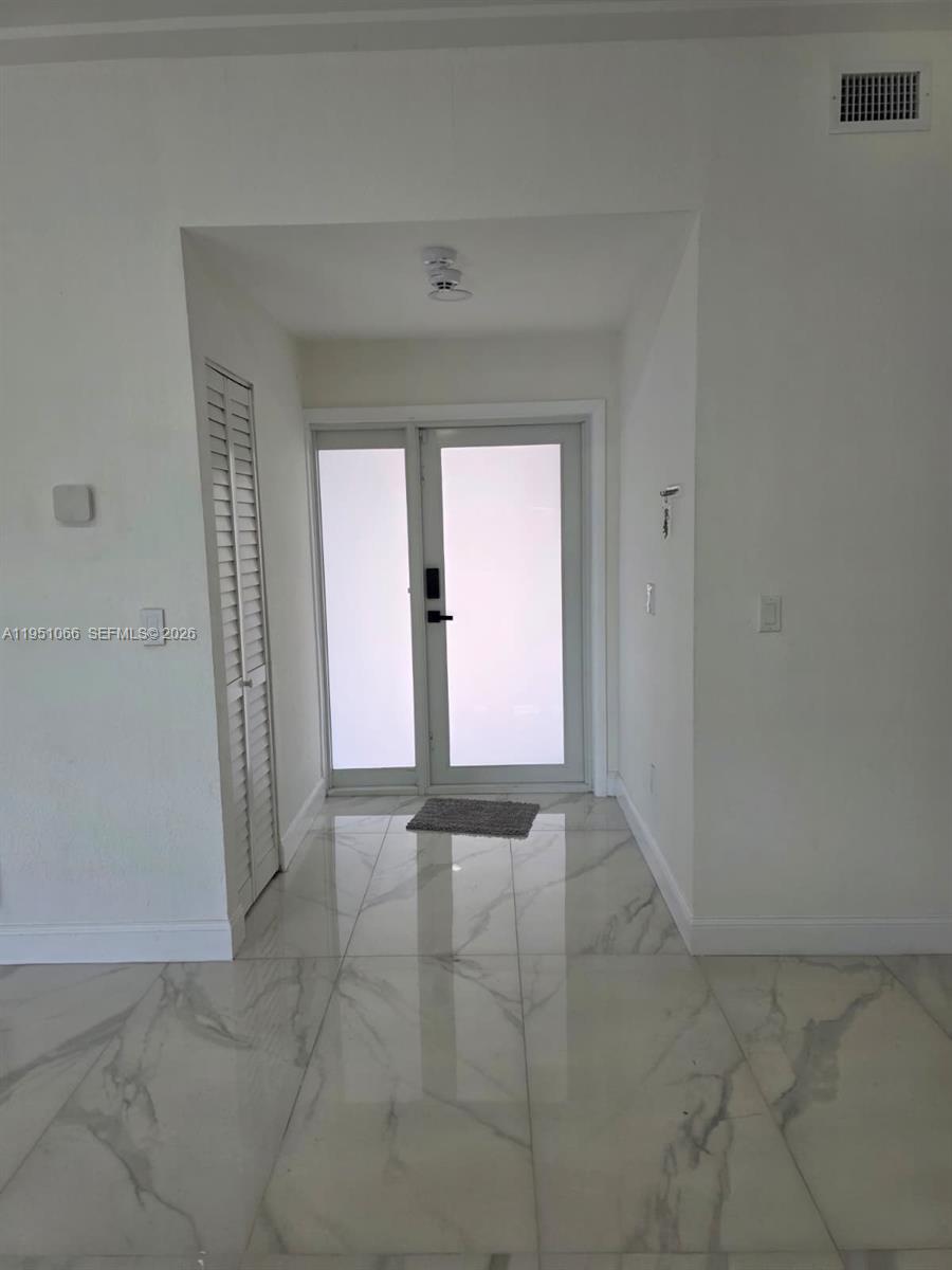 13370 Southwest 261st Terrace Homestead, FL 33032 - Photo 9 of 35 a view of an empty room and window